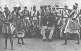 The Dahomey Amazons or Mino were a Fon all-female military regiment of the Kingdom of Dahomey (now Benin) which lasted until the end of the 19th century. The Mino were recruited from among the ahosi ('king's wives') of which there were often hundreds. Some women in Fon society became ahosi voluntarily, while others were involuntarily enrolled if their husbands or fathers complained to the King about their behaviour. Membership among the Mino was supposed to hone any aggressive character traits for the purpose of war. During their membership they were not allowed to have children or be part of married life. Many of them were virgins. The regiment had a semi-sacred status, which was intertwined with the Fon religious beliefs. The Mino trained with intense physical exercise. Discipline was emphasised. In the latter period, they were armed with Winchester rifles, clubs and knives. Units were under female command. Captives who fell into the hands of the Amazons were often decapitated.