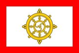The national flag of Sikkim consisted of a Buddhist khorlo prayer wheel with the gankyil as the central element. Until 1967, the previous flag showed a very complex design with a fanciful border and religious pictograms surrounding the khorlo. A more simple design was adopted in 1967 because of the difficulty in duplication of the complex flag. The border became solid red, the pictograms were removed and the wheel was redesigned. With the annexation of Sikkim to India, and with the abolition of the monarchy, the flag was also abolished.